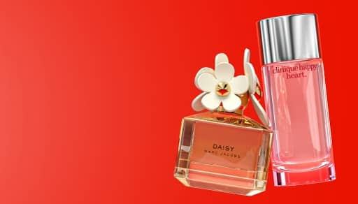 product shot of two perfume bottles on the right side. The first bottle is a Marc Jacobs Daisy perfume leaning on a Clinique Happy perfume bottle.