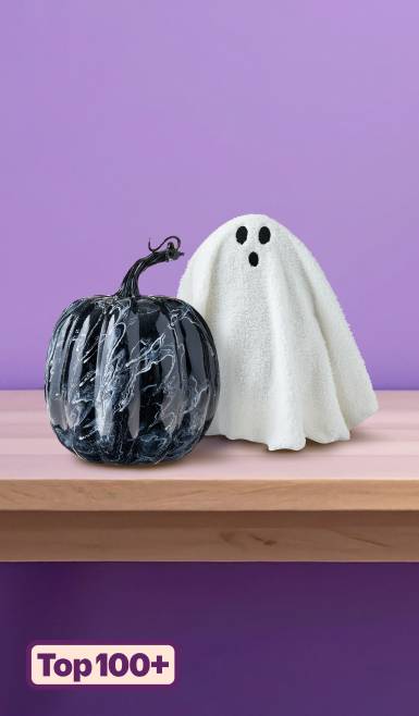 Badge reads: “Top one hundred plus.” Image shows Halloween decor, including a ghost figurine and a black marble pumpkin.