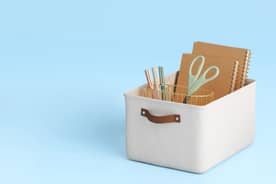 A stylish organization bin filled with essential school supplies.