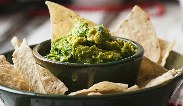 38520-161132_Food_Healthier_Big_Game_Snacks bowl of guacamole and chips