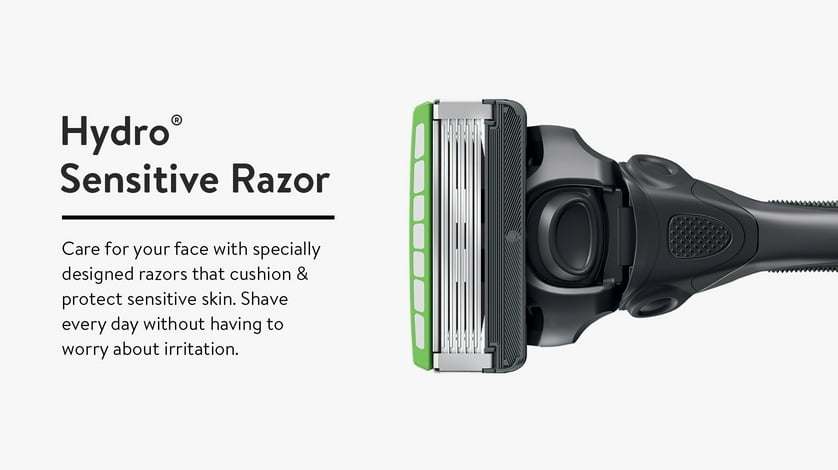 The razor head of a black schick hydro sensitize razor with a green guard on it