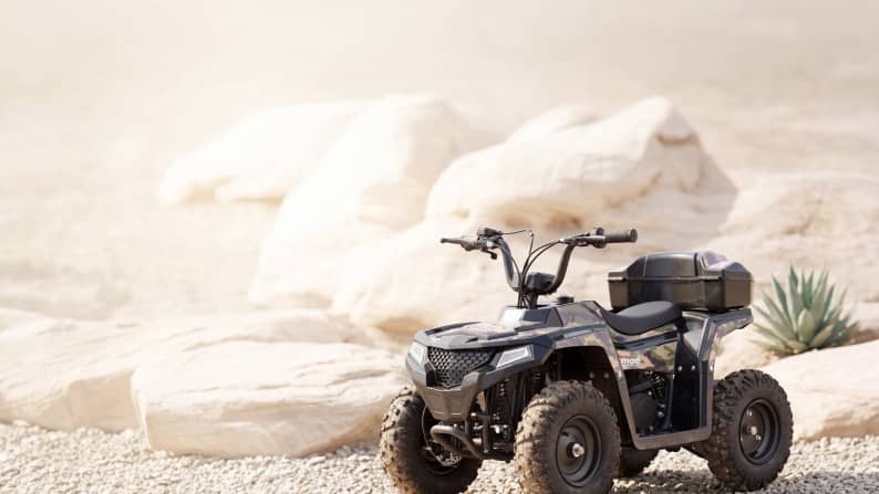 A four-wheeler parked on a rocky road.