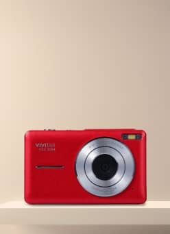 Vivitar VGC 5124 red compact digital camera on a shelf with silver lens and small flash window.