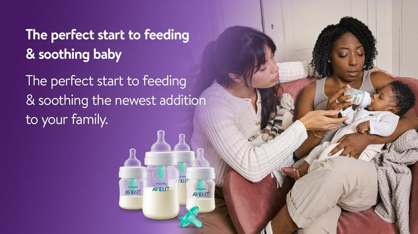 Two women feeding a baby with a Philips Avent baby bottle.