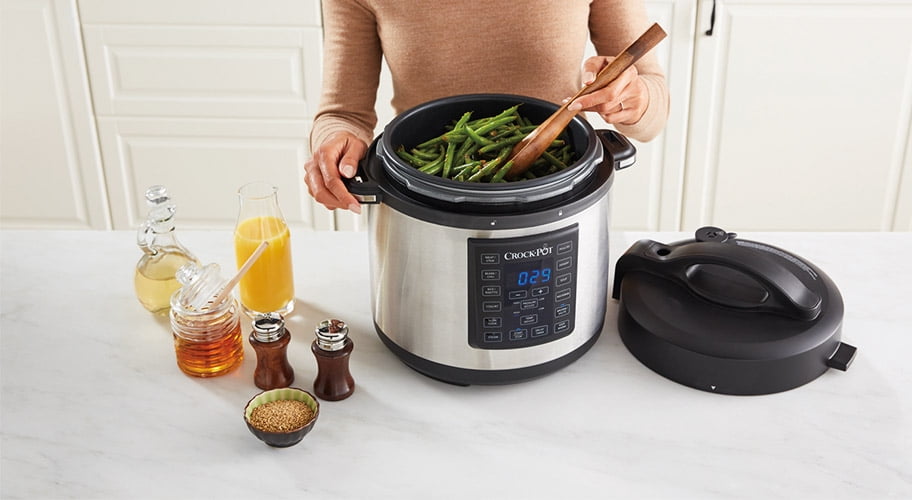 woman cooking beans in crock pot