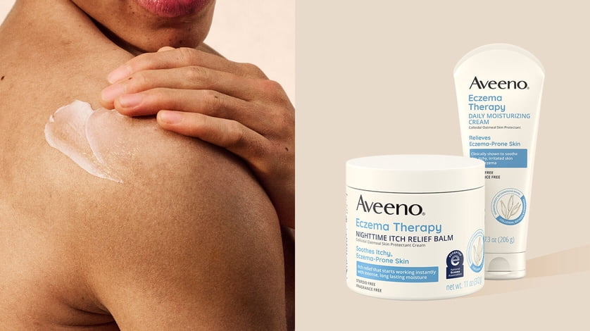 Close up of a model applying lotion on the back of her shoulder next to Aveeno Eczema Therapy itch relief balm and moisturizing cream.