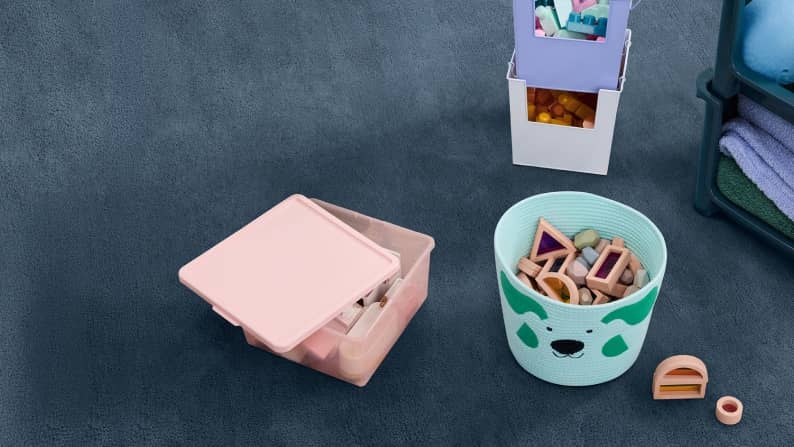 Stackable purple bins with blocks and a light blue animal basket with wooden shapes. Reads: From four ninety-four. Mainstays Kids storage.