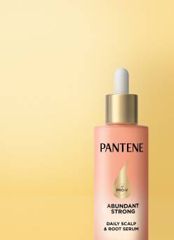 Yellow banner with hair serum and text: Scalp care for healthy hair. Shop now.