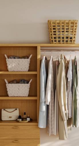 A closet with wood accents is shown with  hanging clothes, storage baskets and a purse.