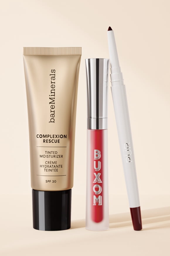 BareMinerals Complexion Rescue tinted moisturizer SPF thirty, Buxom red lip gloss and a white lip pencil stand upright.