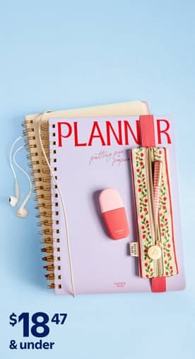 Pink and blue notebooks on a blue desk.