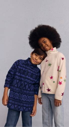 A girl and boy are shown wearing microfleece zip-up jackets.