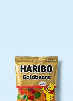 A bag of Haribo Goldbears gummy bears is shown against a light blue background.