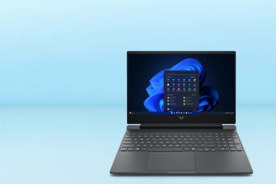 Image shows a mica silver HP Victus laptop with a blue screen on a light blue background.