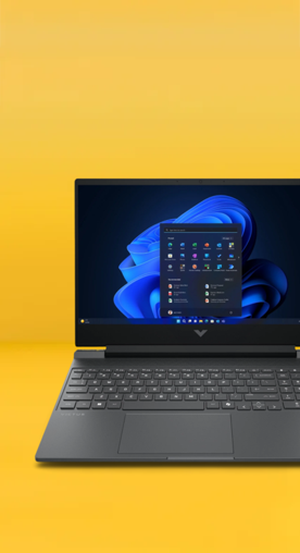 Image shows a mica silver HP Victus laptop with a blue screen on a yellow background.