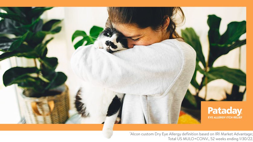 A woman hugs her cat.