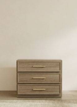 A mid-century modern side table with three drawers.
