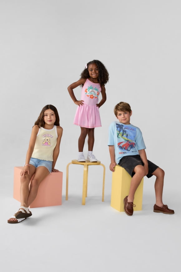 Three kids posing in character-inspired outfits.