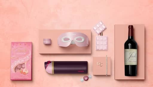 Chocolate, skincare, eye mask, fragrance, wine, bracelet, earrings, water bottle and candy.