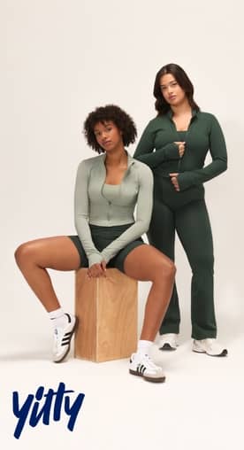 Yitty Active logo lockup. Image of two models standing in green athleisure sets by Yitty Active.