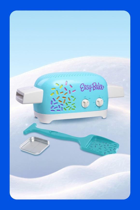 Easy Bake turquoise toy oven with sprinkle design, shown with matching spatula and small metal baking tray.