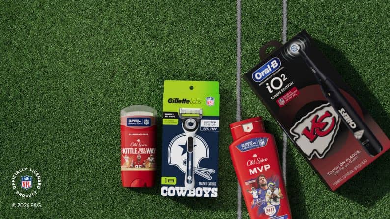 Old Spice deodorant and body wash, Gillette Cowboys razor and Oral B iO2 Chiefs toothbrush on football turf with officially licensed NFL badge.