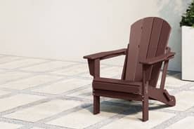 A brown chair on a stone patio. Was $239. Now $79.99.