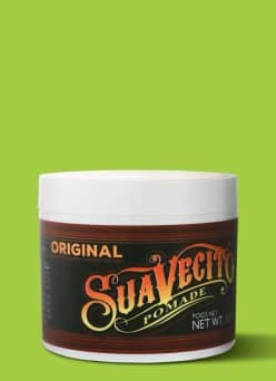 View a container of Suavecito pomade against a green background.