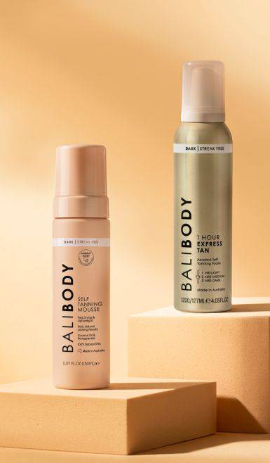 Self-tanning lotion on a cream-colored background.