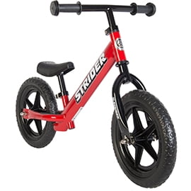 Red toddlers' Strider balance bike with black wheels