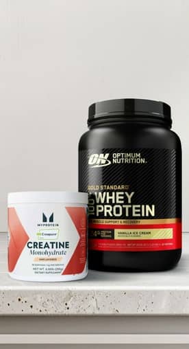 Creatine supplement, Quest chips and a protein shake on a countertop.