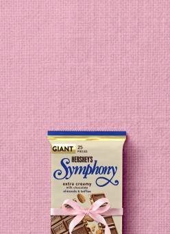 A Hershey’s Symphony chocolate bar with a pink ribbon wrapped around it.