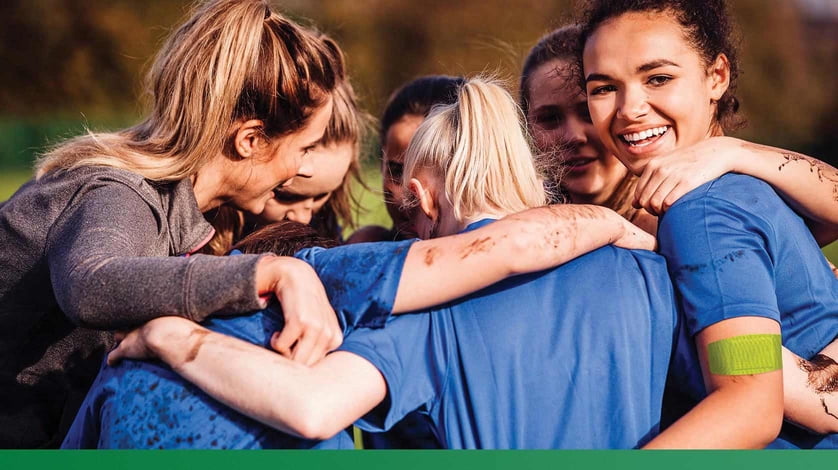 A group of athletes huddle together.