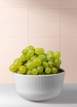 A bowl of green grapes is shown.