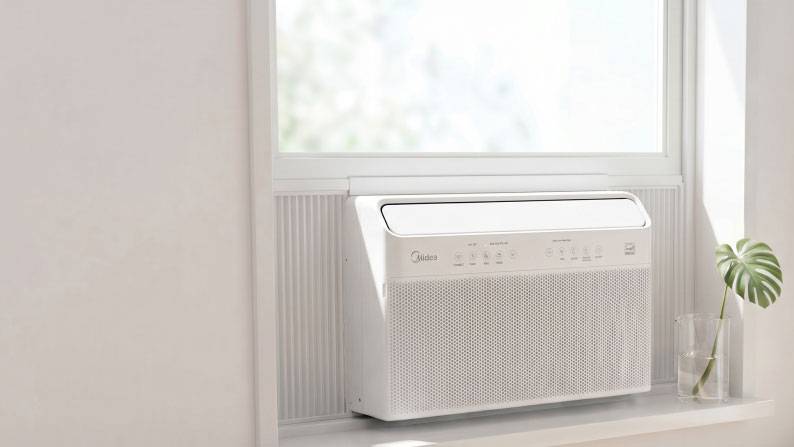 A white wall inset air conditioner unit.