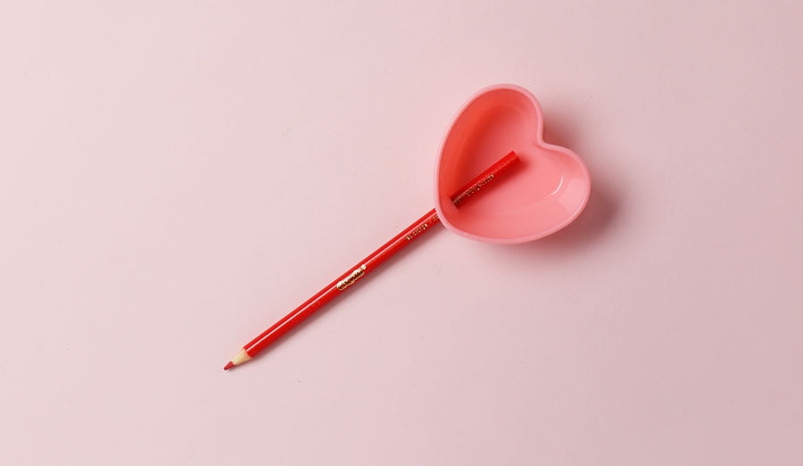 Colored pencil sticking into heart silicon baking cup