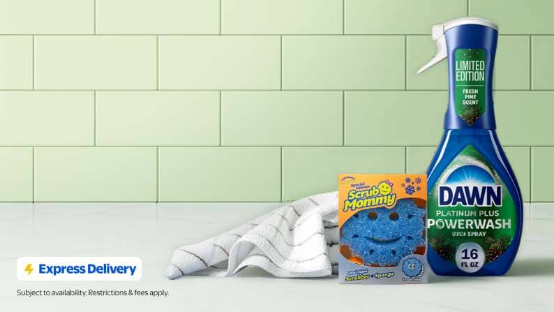 Express Delivery. A blue snowflake Scrub Mommy and a bottle of fresh pine scent Dawn Powerwash on a white counter against a green tile backsplash.
