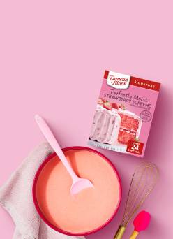 Duncan Hines strawberry cake mix and a bowl with utensils
