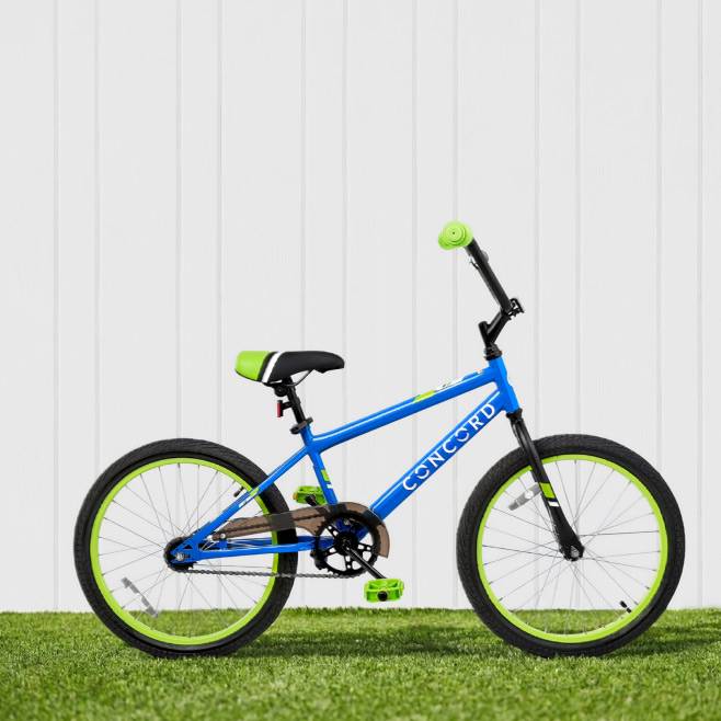 Blue bike with light green details standing on grass.