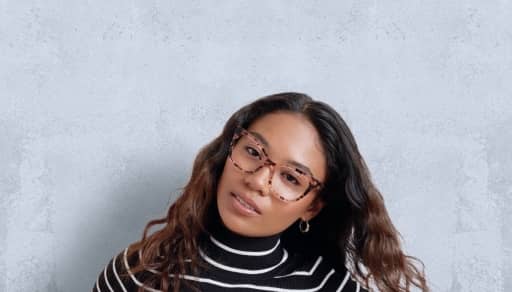 A woman wearing stylish eyeglasses. Advertising women’s frames.