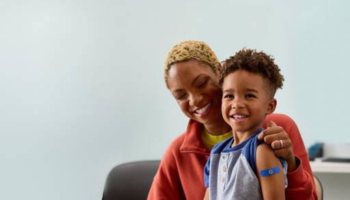 A mom and son are shown smiling.