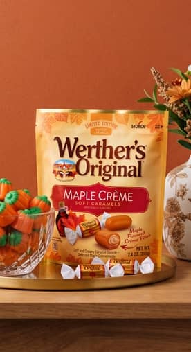 A bowl of candy pumpkins is next to a bag of Werther’s Original caramel apple candy.