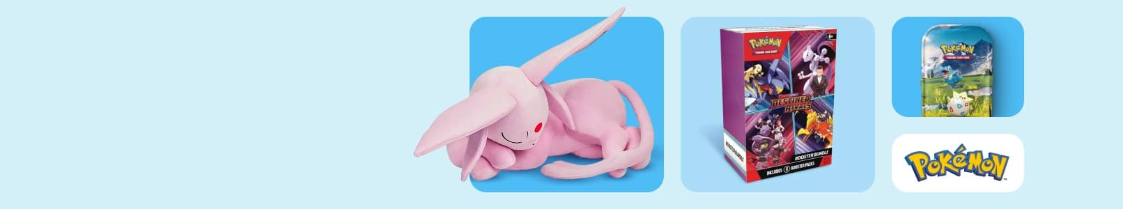 Sleeping Espeon plushie. Boxes of Pokémon booster cards with Pokémon logo.