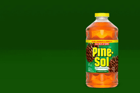 Image shows an orange Pine-Sol multi-surface cleaner bottle with a yellow cap on a dark green background.