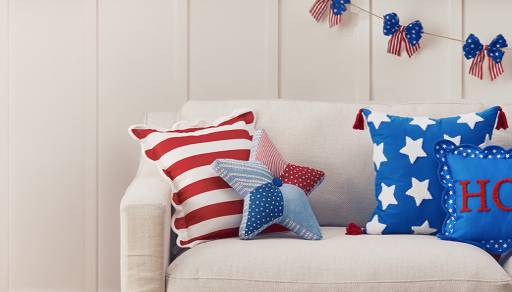 Couches with USA pillows, table, rug and storage.