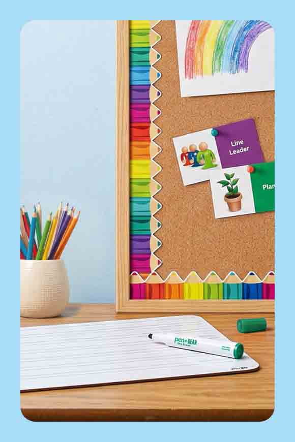 A bulletin board covered in paper patterned with colorful pencils.