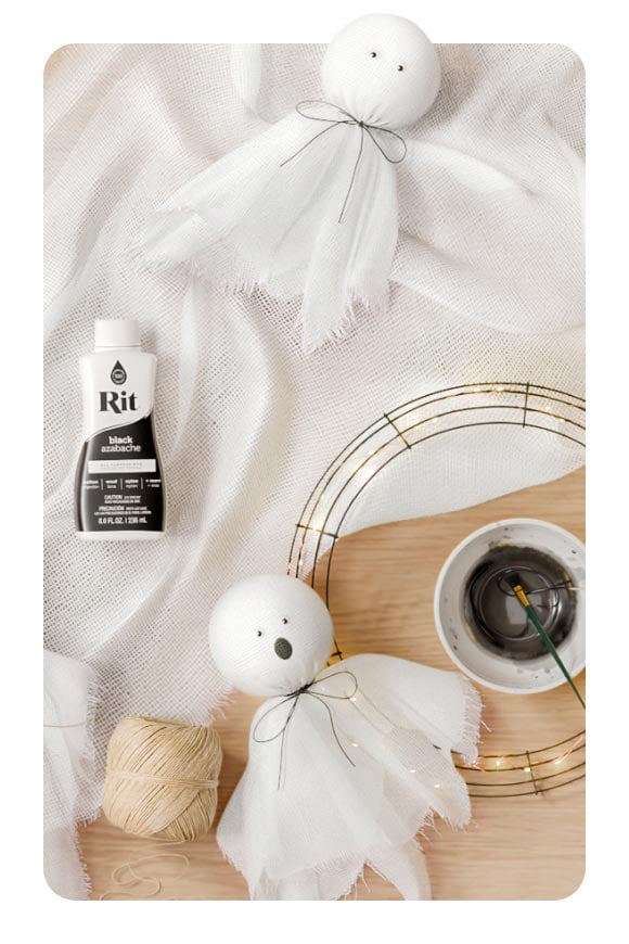 White fabric, Rit black paint, twine and small crafted cloth ghosts.