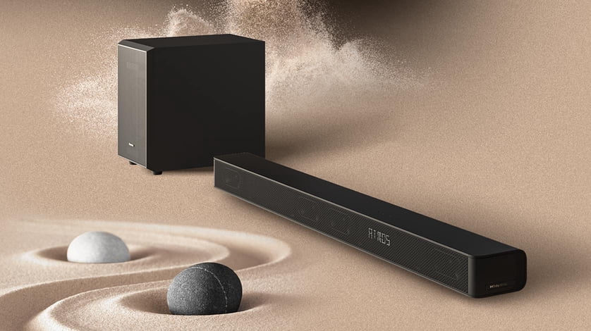 The Hisense Three Point One Point Two C.h. Three Sixty W Soundbar with Wireless Subwoofer sits in a sand background.