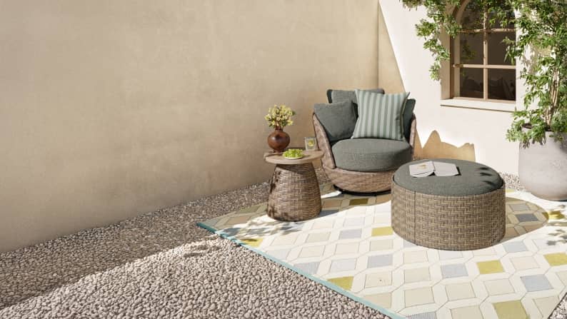 A brown and blue patio set on top of a green and beige rug.