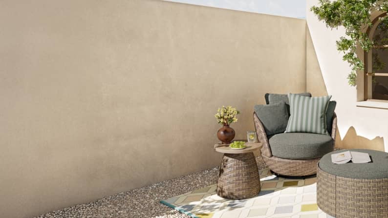 A brown and blue patio set on top of a green and beige rug.